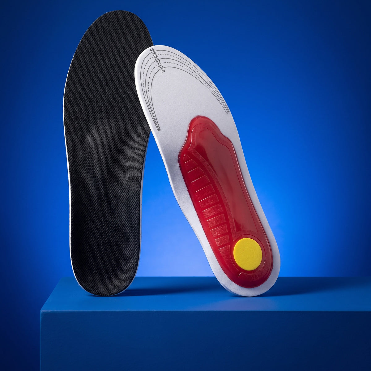 SoftInch Arch Support Insoles on a blue stand: the black top, and the red arch shell with a yellow heel pad underneath