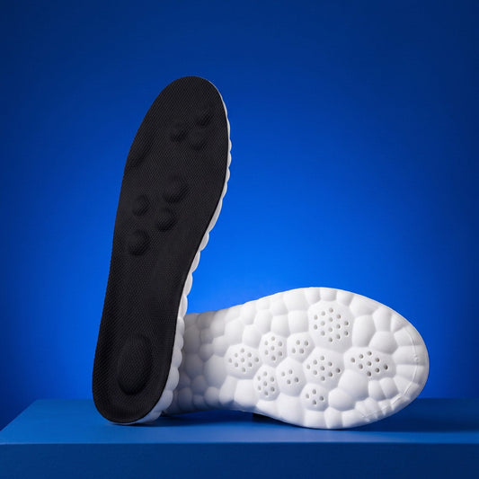 SoftInch Comfort Insoles in black on a blue stand, the massage dot top and the cloud foam underside