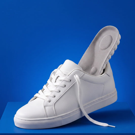 A gray SoftInch Comfort Insole sliding into a white sneaker