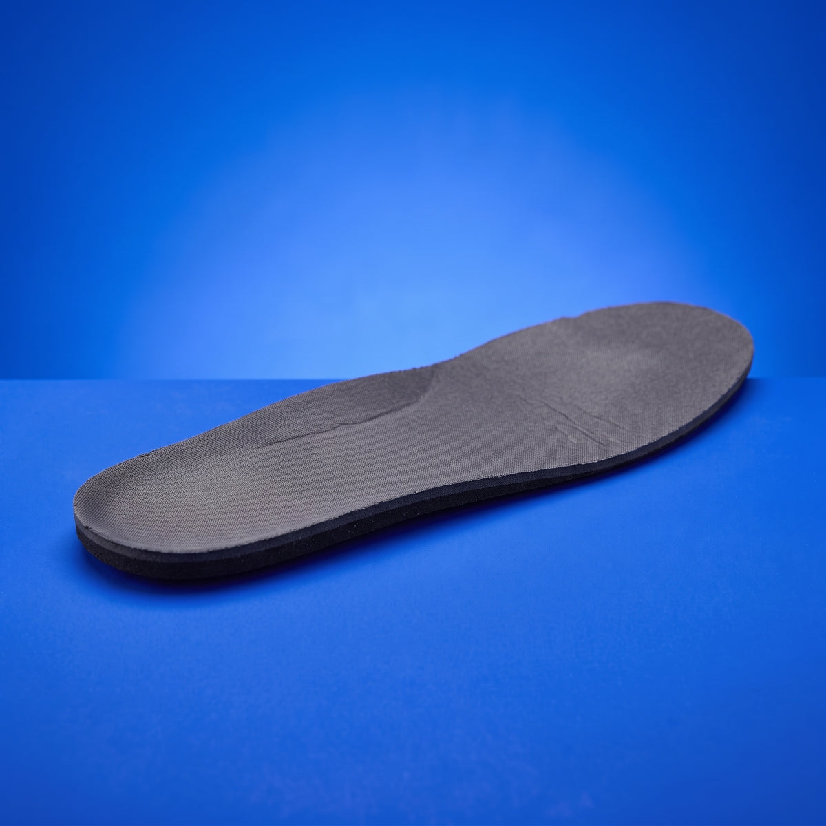 A thin, flat stock insole in the same place