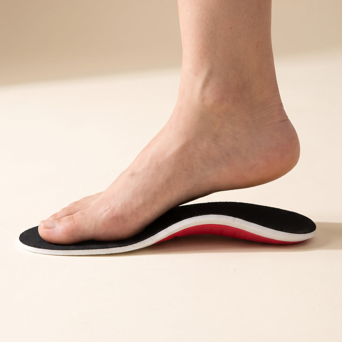 A bare foot stepping onto an Arch Support Insole, the raised arch under the inside of the foot