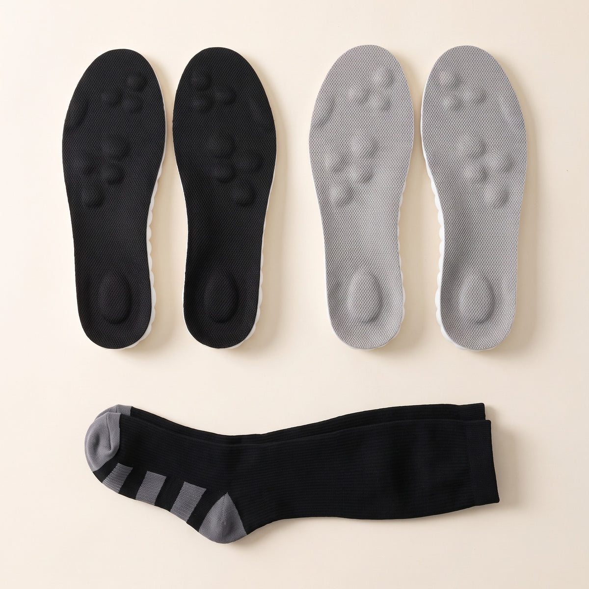 Two pairs of SoftInch Comfort Insoles in black and gray with a free pair of compression socks